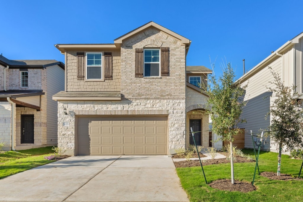 front of property with a front yard and a garage