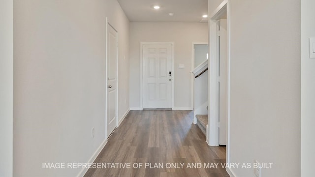 corridor with hardwood / wood-style floors