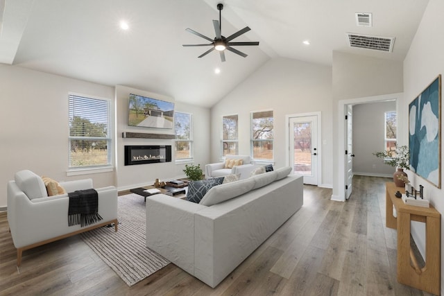 living room with high vaulted ceiling, wood-type flooring, and ceiling fan