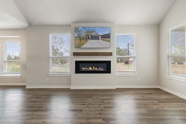 unfurnished living room with dark wood-type flooring and vaulted ceiling