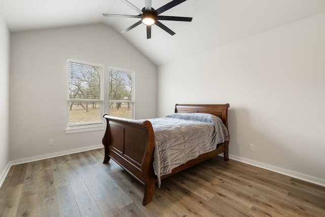 bedroom with wood-type flooring, ceiling fan, and vaulted ceiling