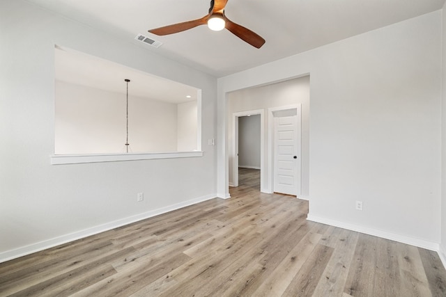 unfurnished room with light wood-type flooring and ceiling fan