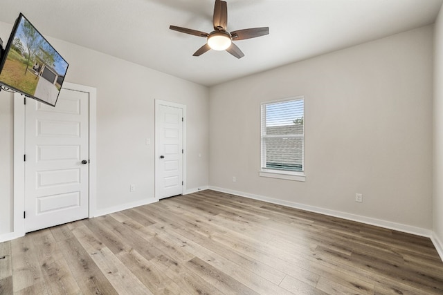 unfurnished bedroom featuring light wood-type flooring and ceiling fan