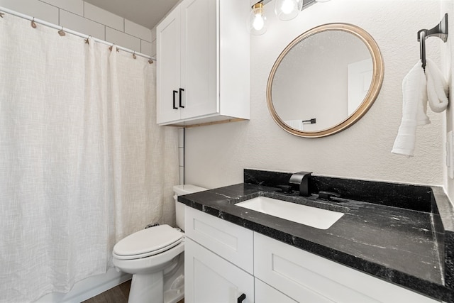 bathroom with vanity, hardwood / wood-style flooring, and toilet