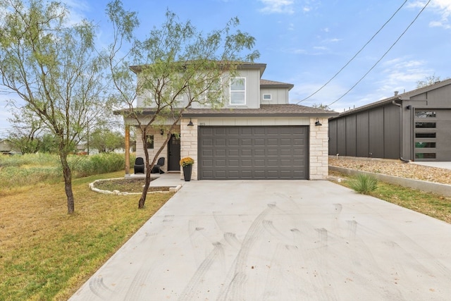 view of front of property with a garage and a front yard