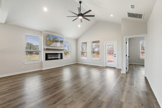 unfurnished living room featuring high vaulted ceiling, dark wood-type flooring, and ceiling fan