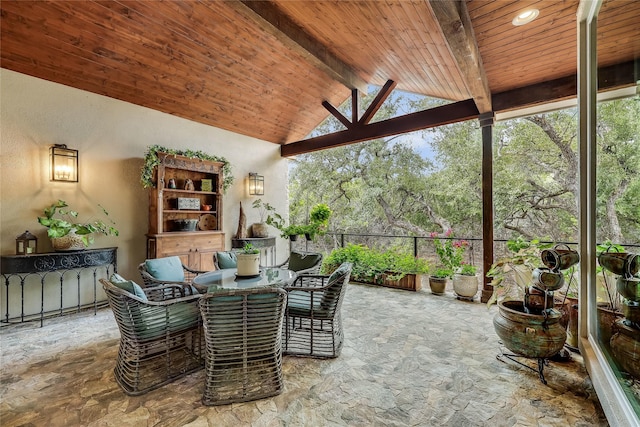 sunroom with lofted ceiling with beams