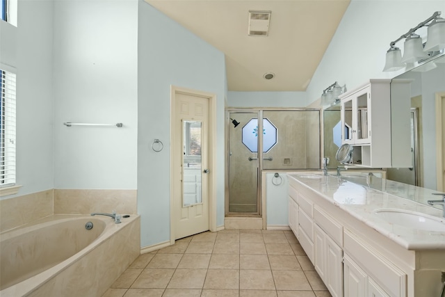 bathroom with tile patterned flooring, vanity, lofted ceiling, and shower with separate bathtub