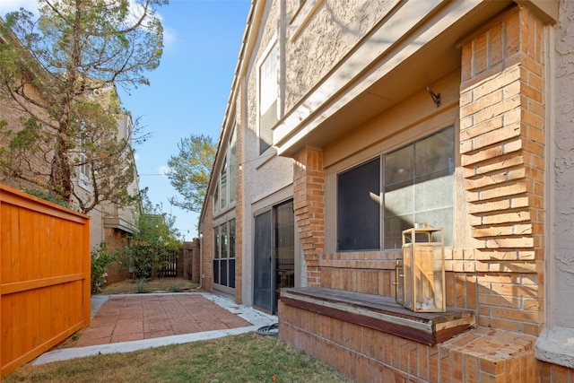 view of side of property with a patio area