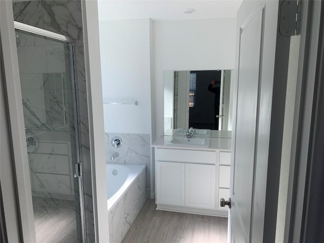 bathroom featuring vanity, hardwood / wood-style flooring, and independent shower and bath