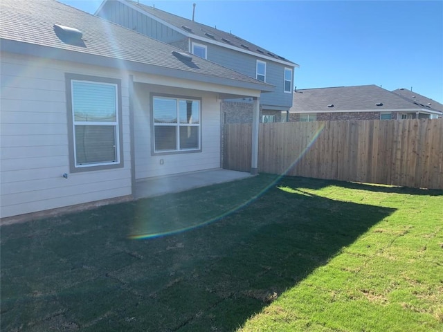 rear view of property with a lawn