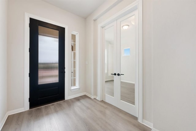 foyer entrance with light hardwood / wood-style floors