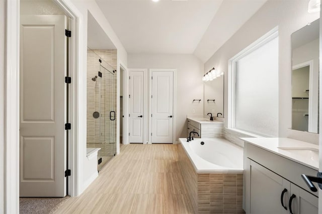 bathroom featuring vanity and independent shower and bath