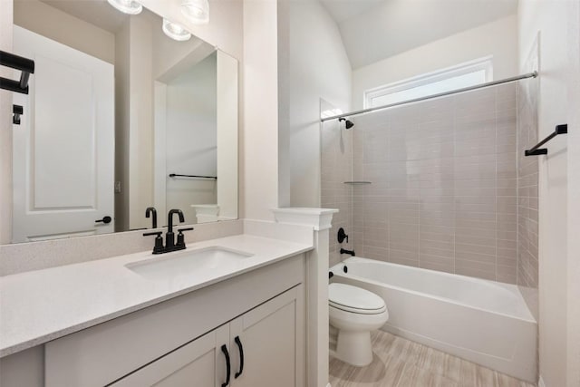 full bathroom with wood-type flooring, vanity, toilet, and tiled shower / bath