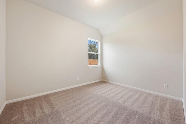 unfurnished room with carpet and lofted ceiling