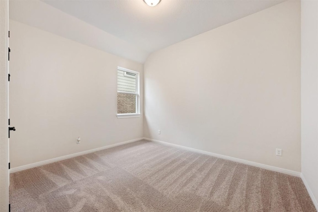 unfurnished room with light carpet and vaulted ceiling