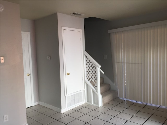 staircase with tile patterned floors