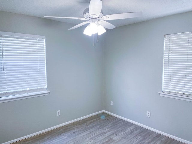 empty room featuring hardwood / wood-style flooring and ceiling fan