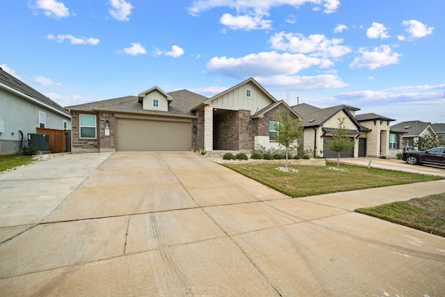 view of front of house with brick siding, central air condition unit, concrete driveway, an attached garage, and a front lawn