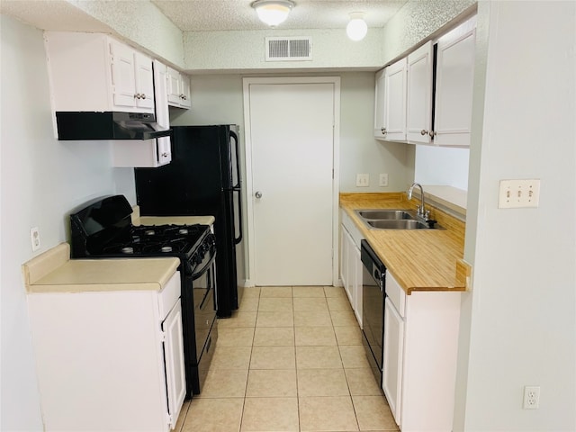 kitchen featuring dishwasher, sink, light tile patterned flooring, white range, and white cabinets