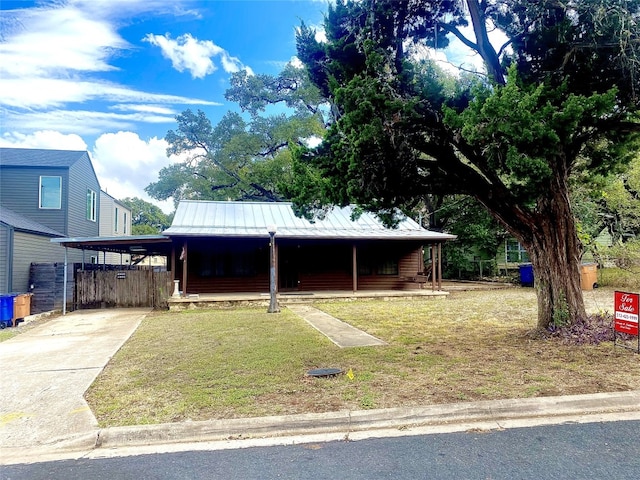 view of front facade with a carport and a front lawn