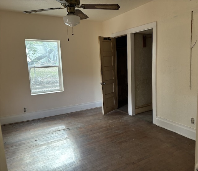 unfurnished bedroom with ceiling fan and dark hardwood / wood-style floors