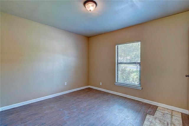 empty room with hardwood / wood-style floors