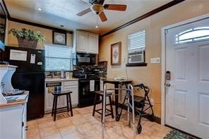 kitchen featuring black appliances, white cabinets, and ornamental molding