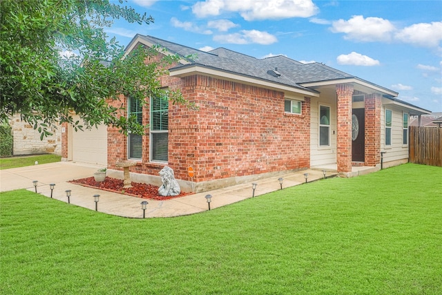 exterior space featuring a garage and a yard