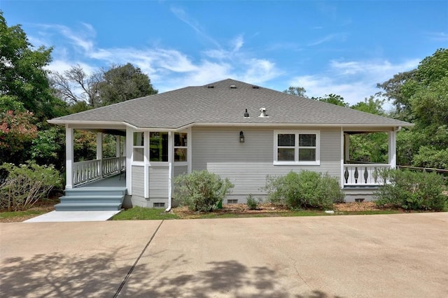 rear view of house featuring covered porch