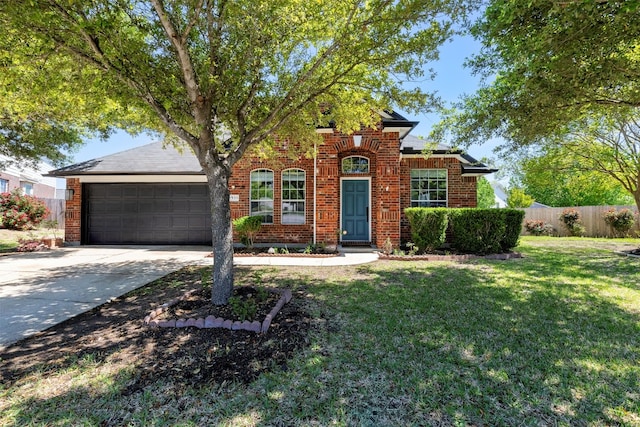 view of front of property featuring a garage and a front lawn