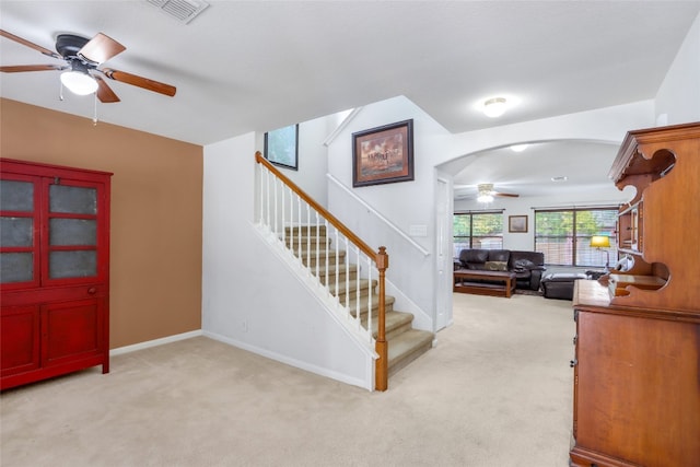 stairway with carpet and ceiling fan