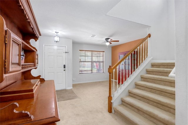 carpeted foyer featuring ceiling fan