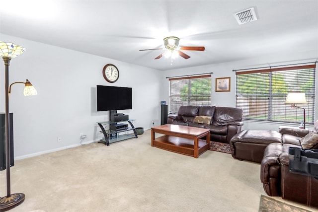 carpeted living room with ceiling fan