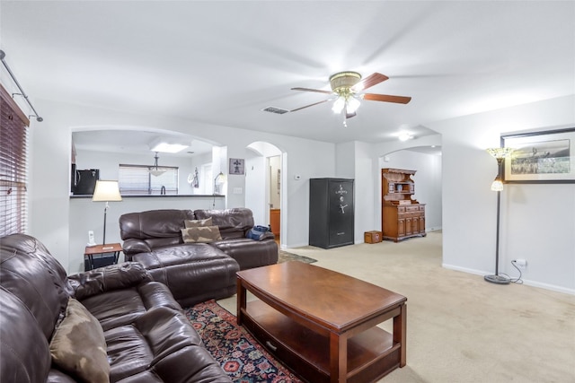 carpeted living room featuring ceiling fan