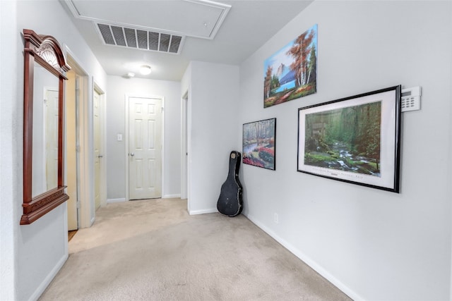 hallway featuring light colored carpet