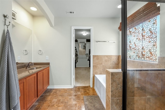 bathroom featuring a tub and vanity