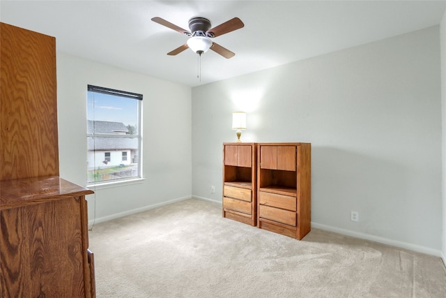 unfurnished bedroom featuring ceiling fan and light carpet