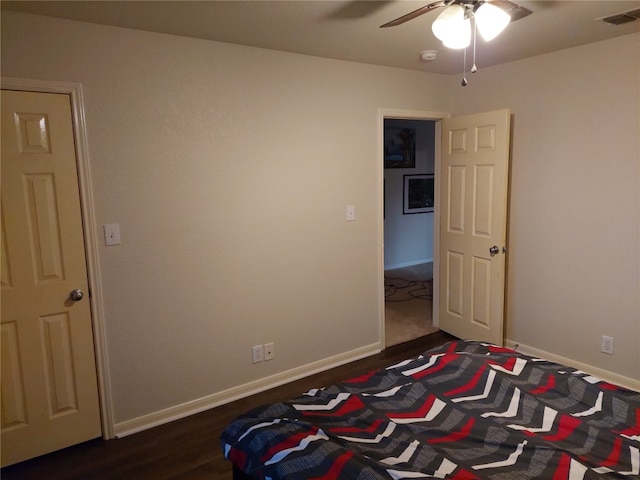 unfurnished bedroom with ceiling fan and dark hardwood / wood-style floors