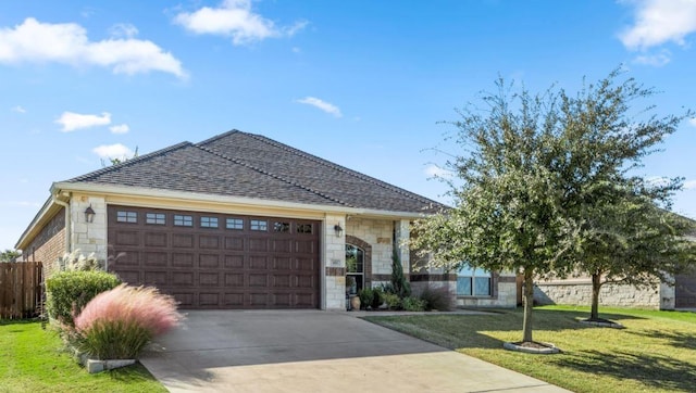 view of front of home with a garage and a front lawn