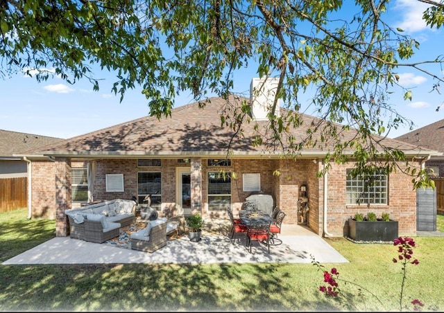 back of property featuring a yard, outdoor lounge area, and a patio