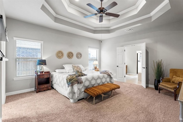 bedroom with ceiling fan, ornamental molding, a tray ceiling, and light carpet