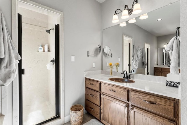 bathroom with vanity and a shower with door