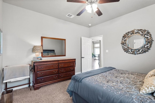 bedroom with ceiling fan and light colored carpet