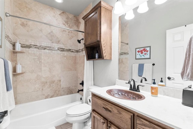 full bathroom featuring vanity, toilet, and tiled shower / bath combo