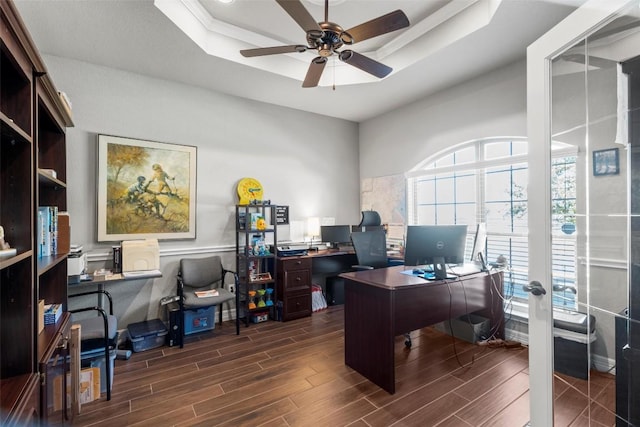 office space featuring ceiling fan and a raised ceiling