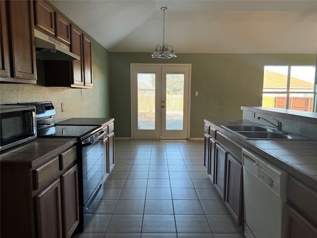 kitchen featuring stainless steel range with electric cooktop, white dishwasher, sink, tile counters, and a chandelier