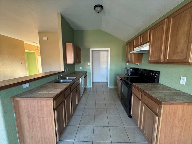 kitchen with vaulted ceiling, kitchen peninsula, sink, light tile patterned flooring, and appliances with stainless steel finishes