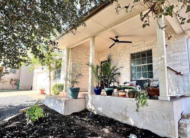 view of patio featuring ceiling fan, covered porch, and a garage