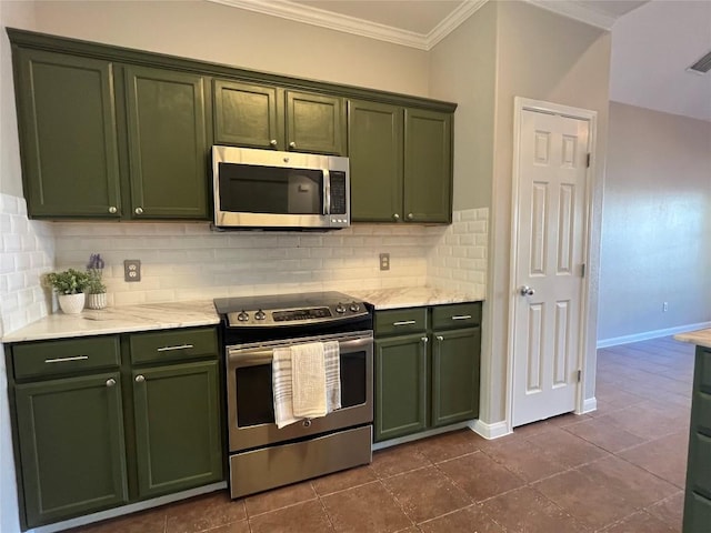 kitchen with dark tile patterned flooring, decorative backsplash, stainless steel appliances, and green cabinetry